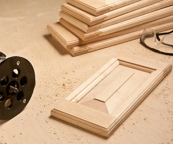 A log of wooden blocks with intricate designs made using drill for door manufacturing units