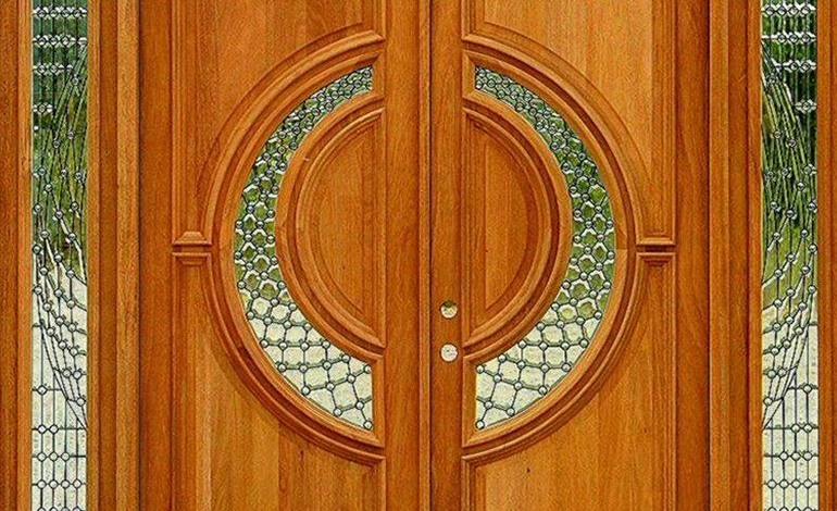 Beautiful circular-patterned wooden double door with stylish glass and detailed design work.